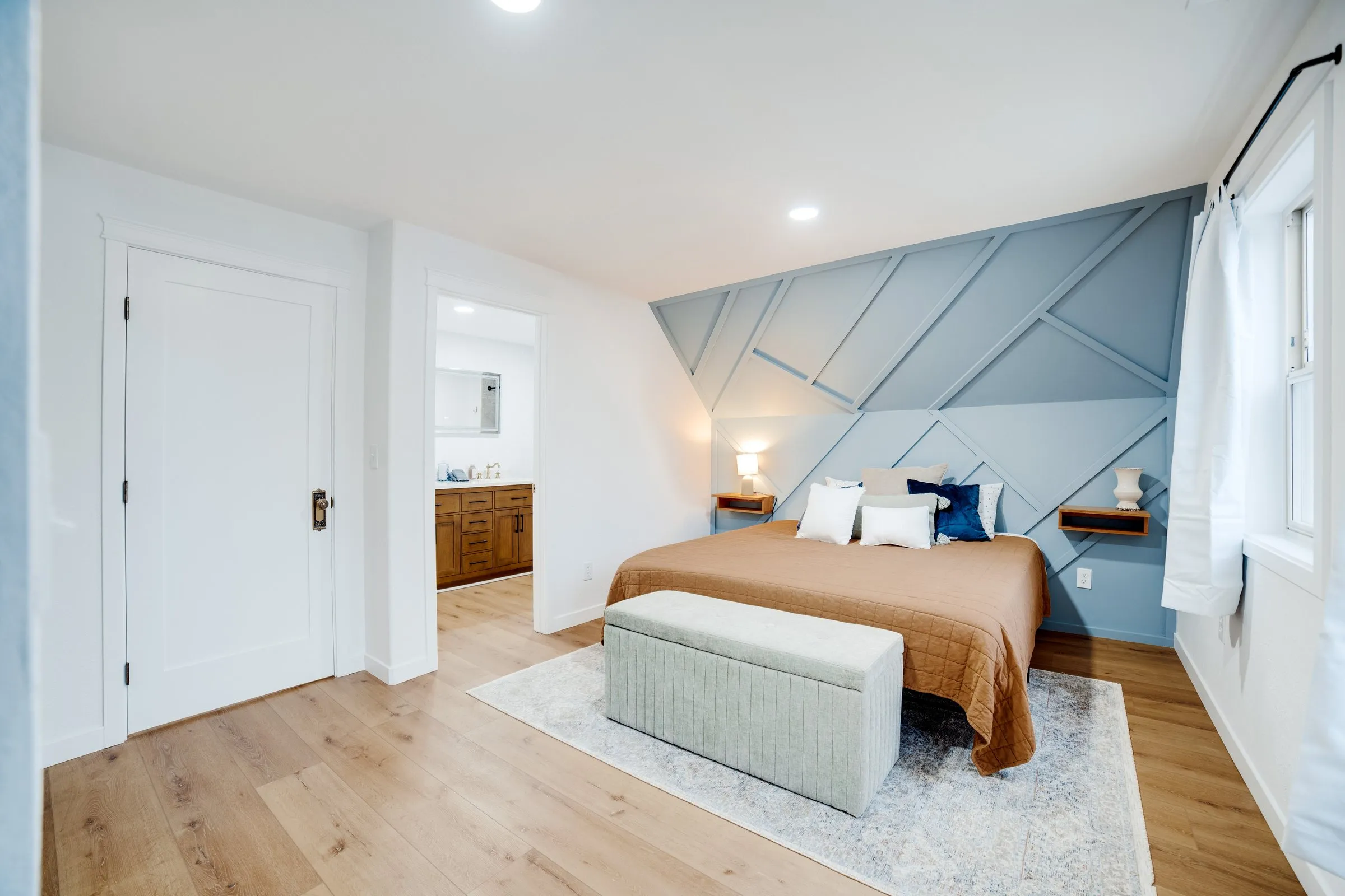Blue bedroom with doorway to its own bathroom