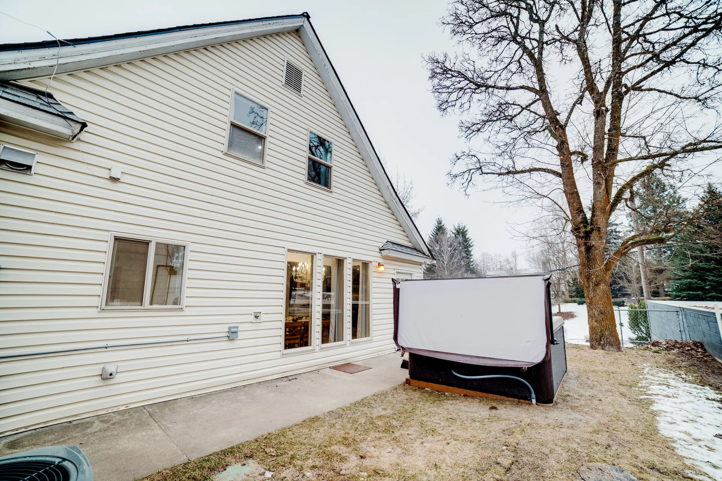 Side yard and exterior of Jackass Manor with the hot tub