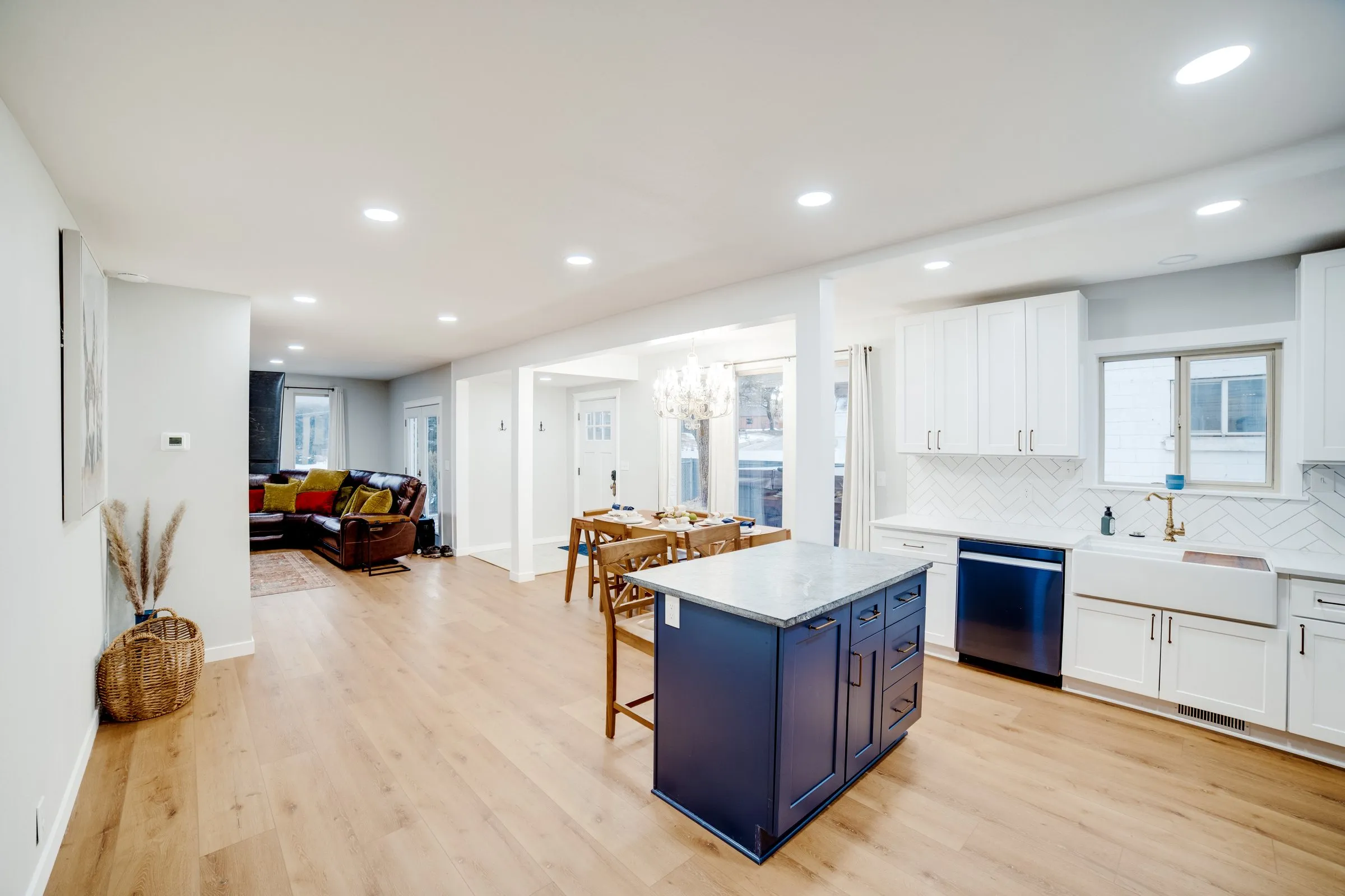 Navy kitchen island looking through to the living room with leather sectional