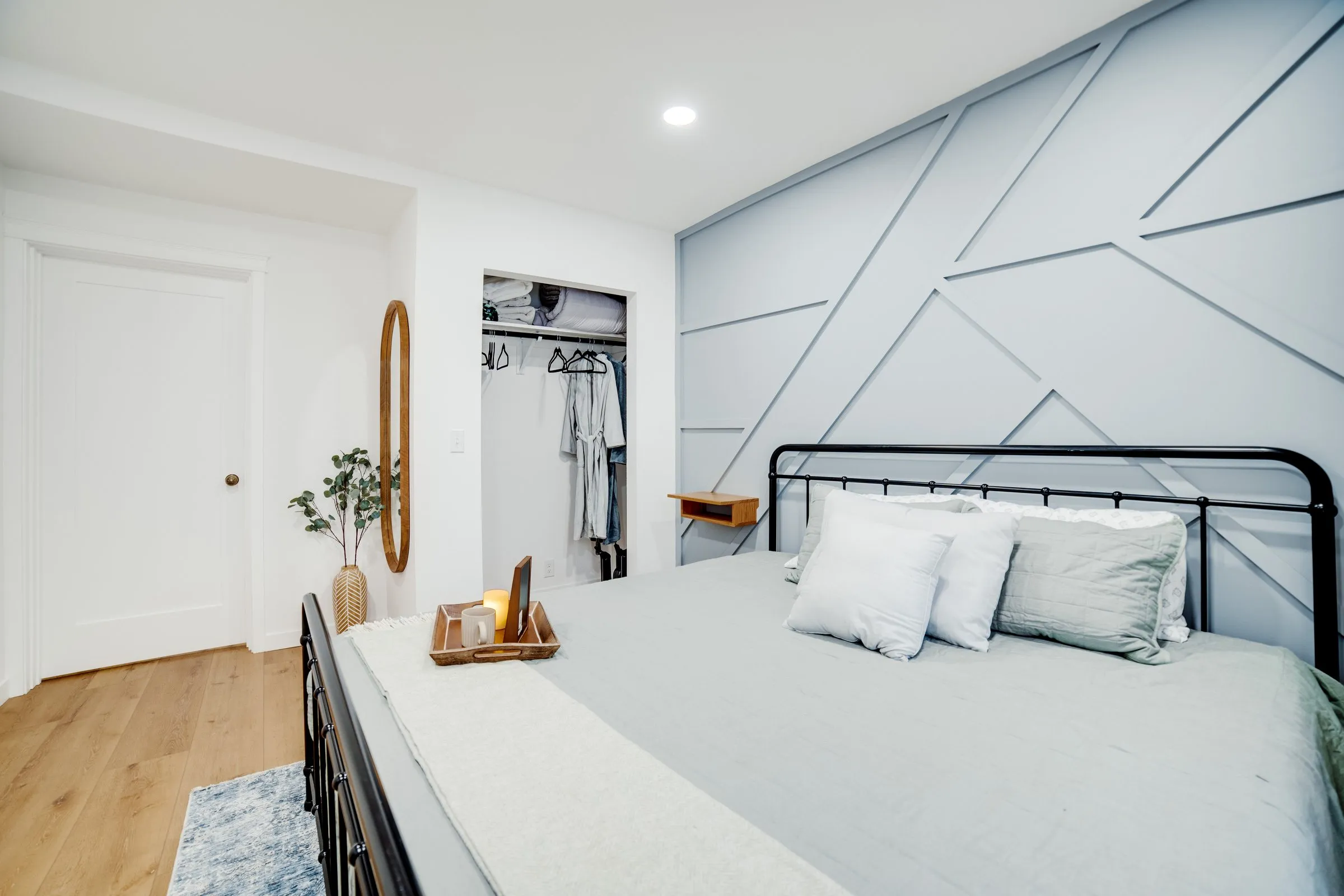 Main-floor bedroom with closet and bedside candle tray